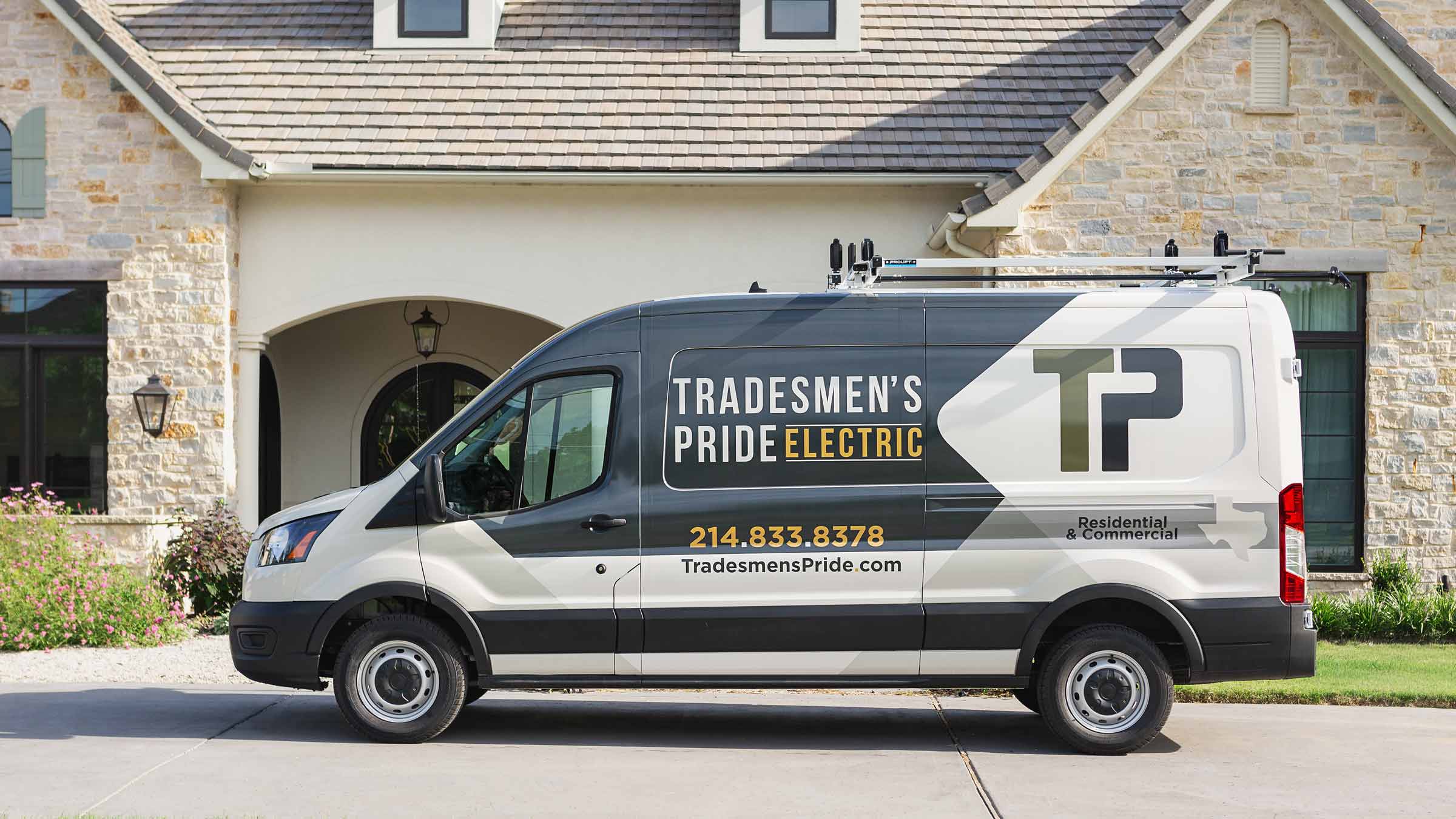Tradesmen's Pride service van in front of a home
